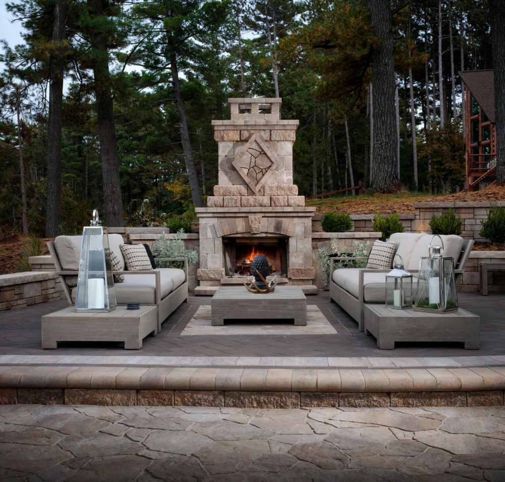 brown firepit with gray couches and table sitting area