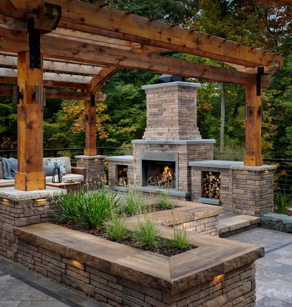 paved area with burning firepit and brown wood covering