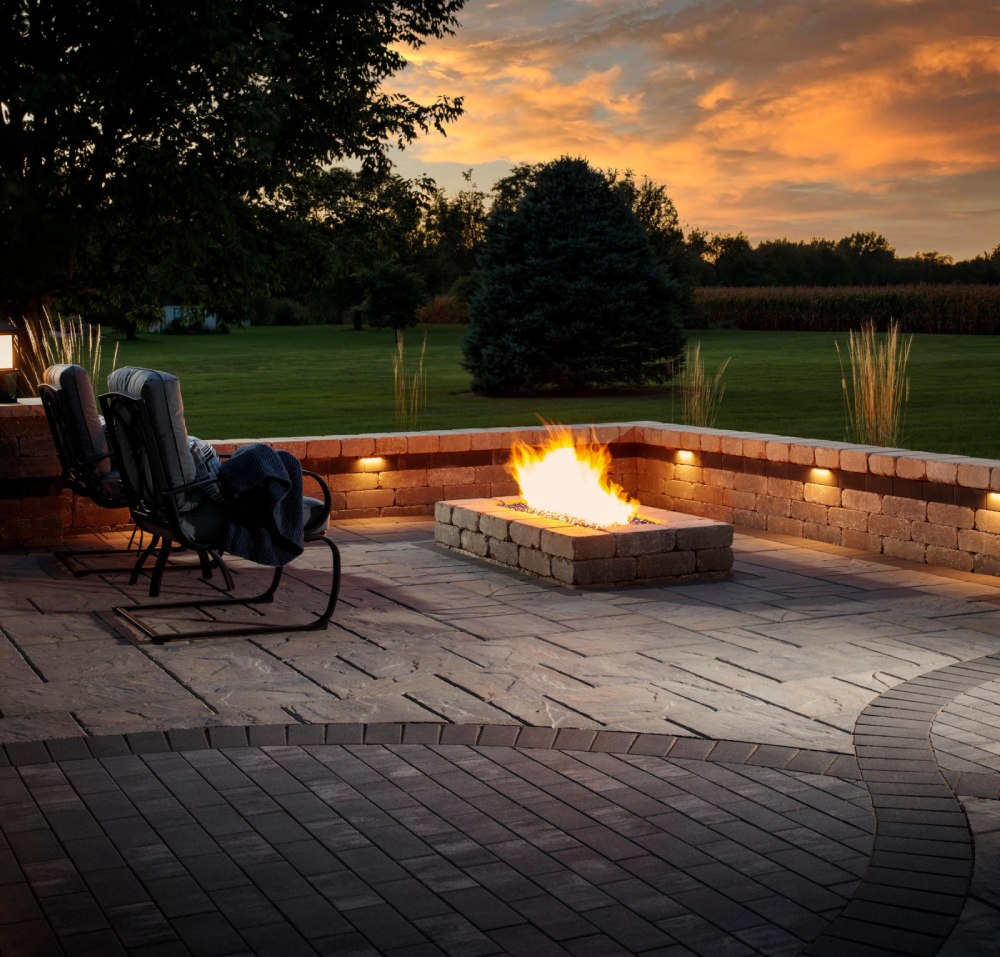 paved area with firepit and sunset