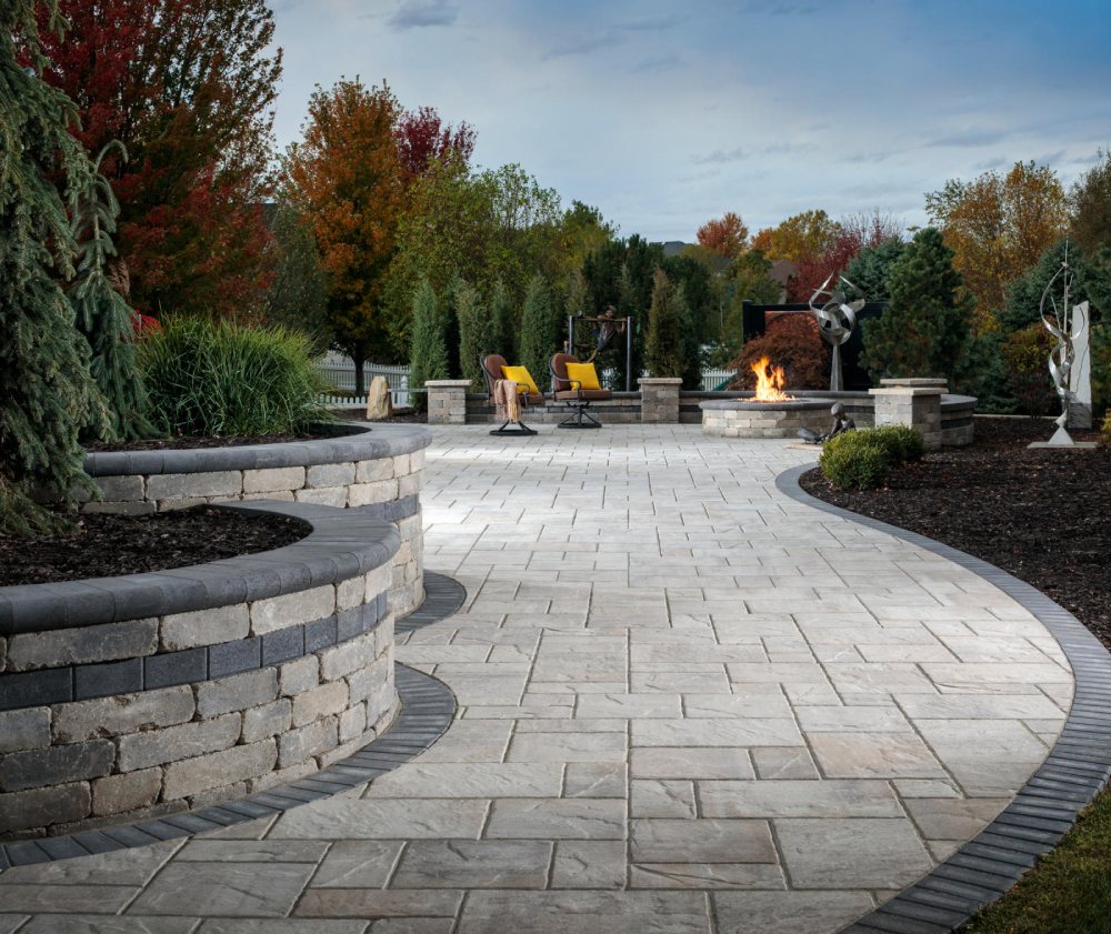 paved area walkway with brown cushioned chairs and yellow pillows