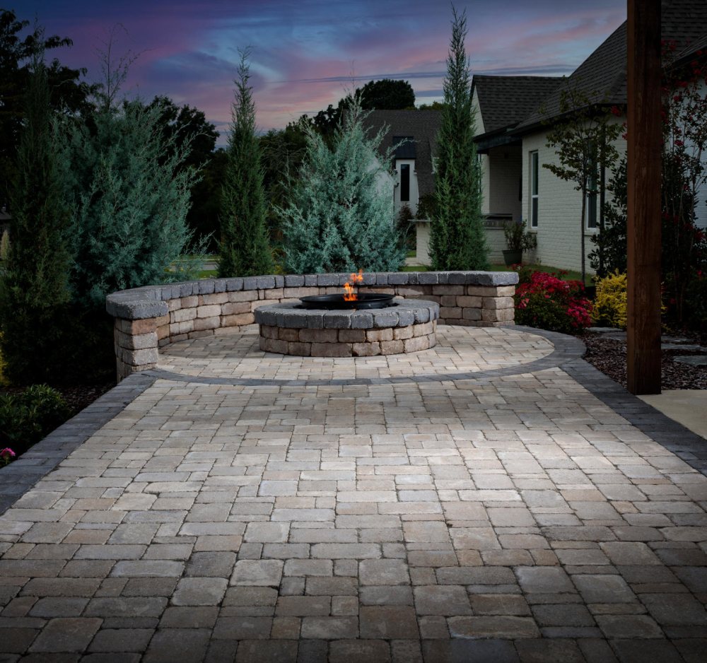 paved area patio with firepit and trees